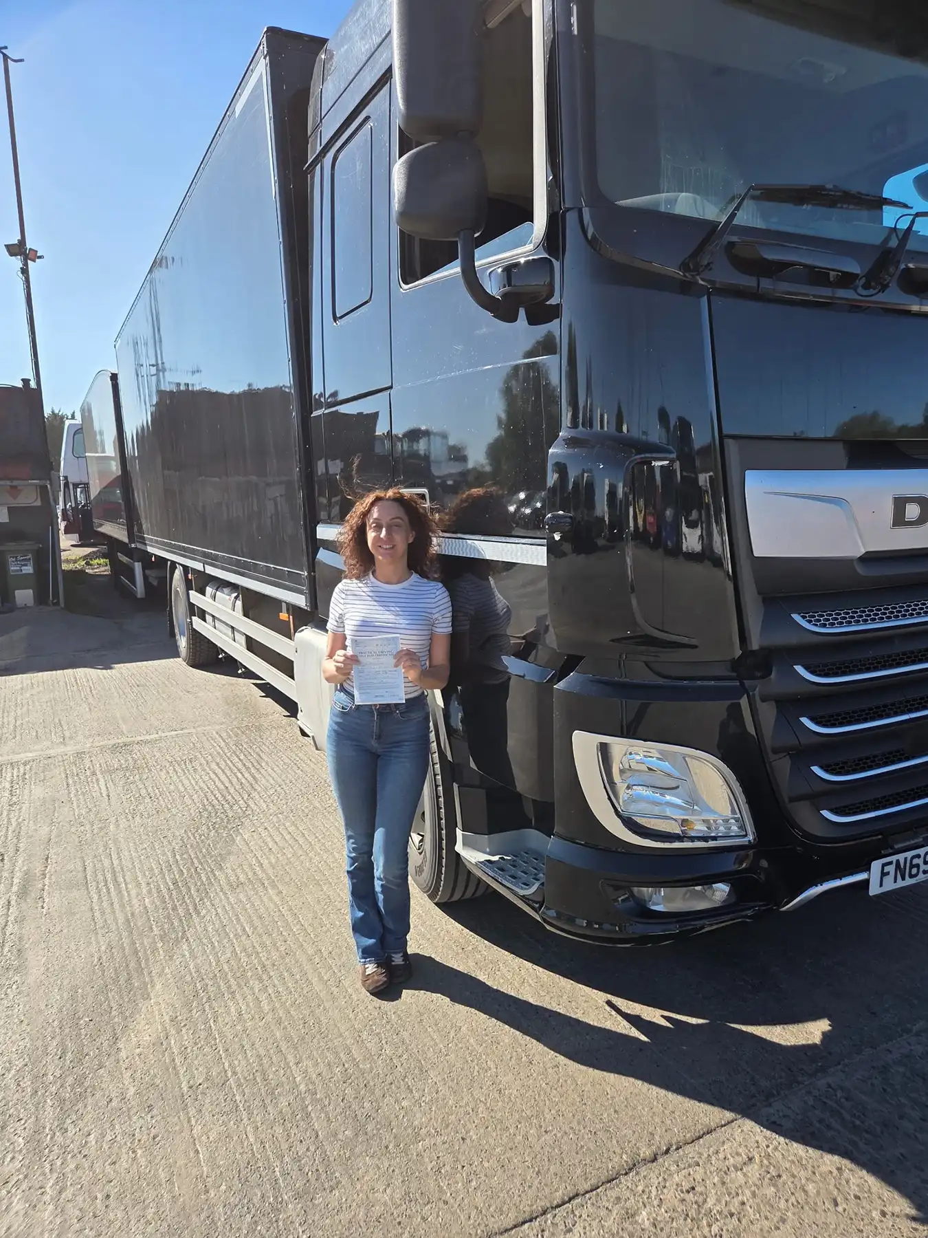 woman next to black lorry